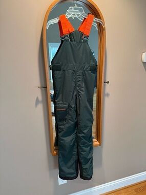 Helly Hansen Green Snow Overalls with Orange Straps.